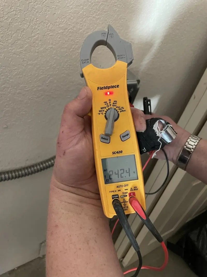 Voltage testing with clamp meter during Outlet Installation in Karns